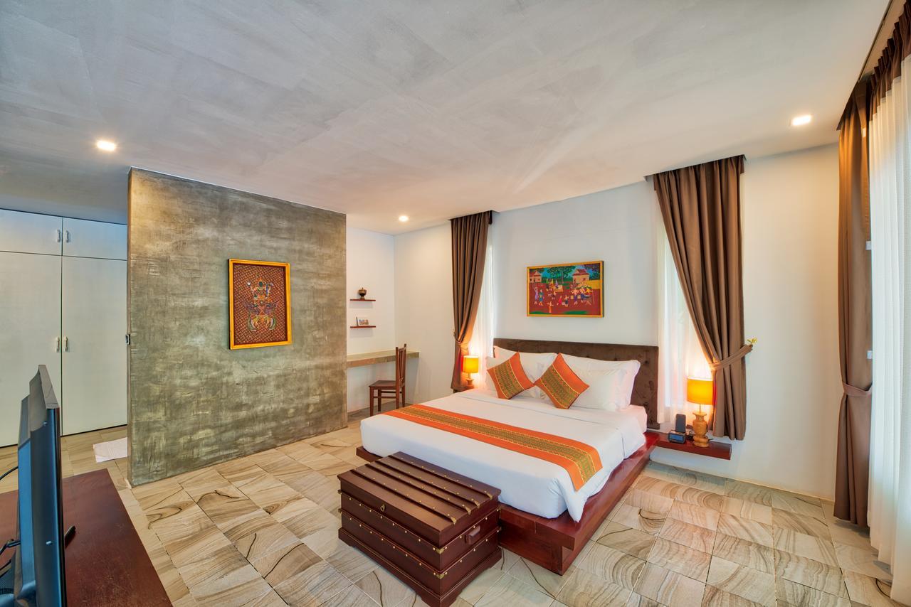 Mane Village Suites Siem Reap Exterior foto A bedroom at the hotel